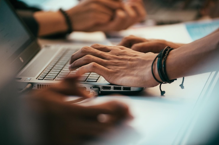 close-up-hands-using-laptop-office_1048944-24858979